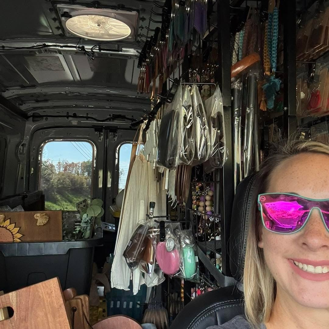 Courtney in the van packed with hats and product on a market morning