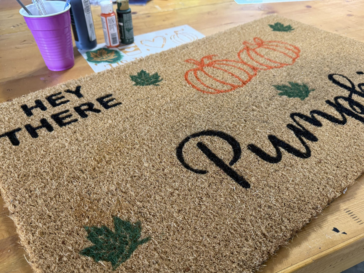 Fall Paint Party - Fall doormat with stencils and paint on the studio table
